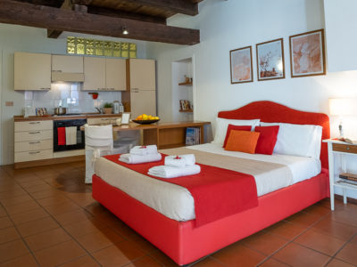 letto rosso e cucina monolocale residence ferraud
